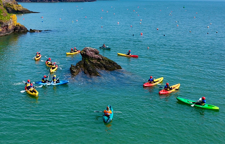 kayak group exploring coves cover